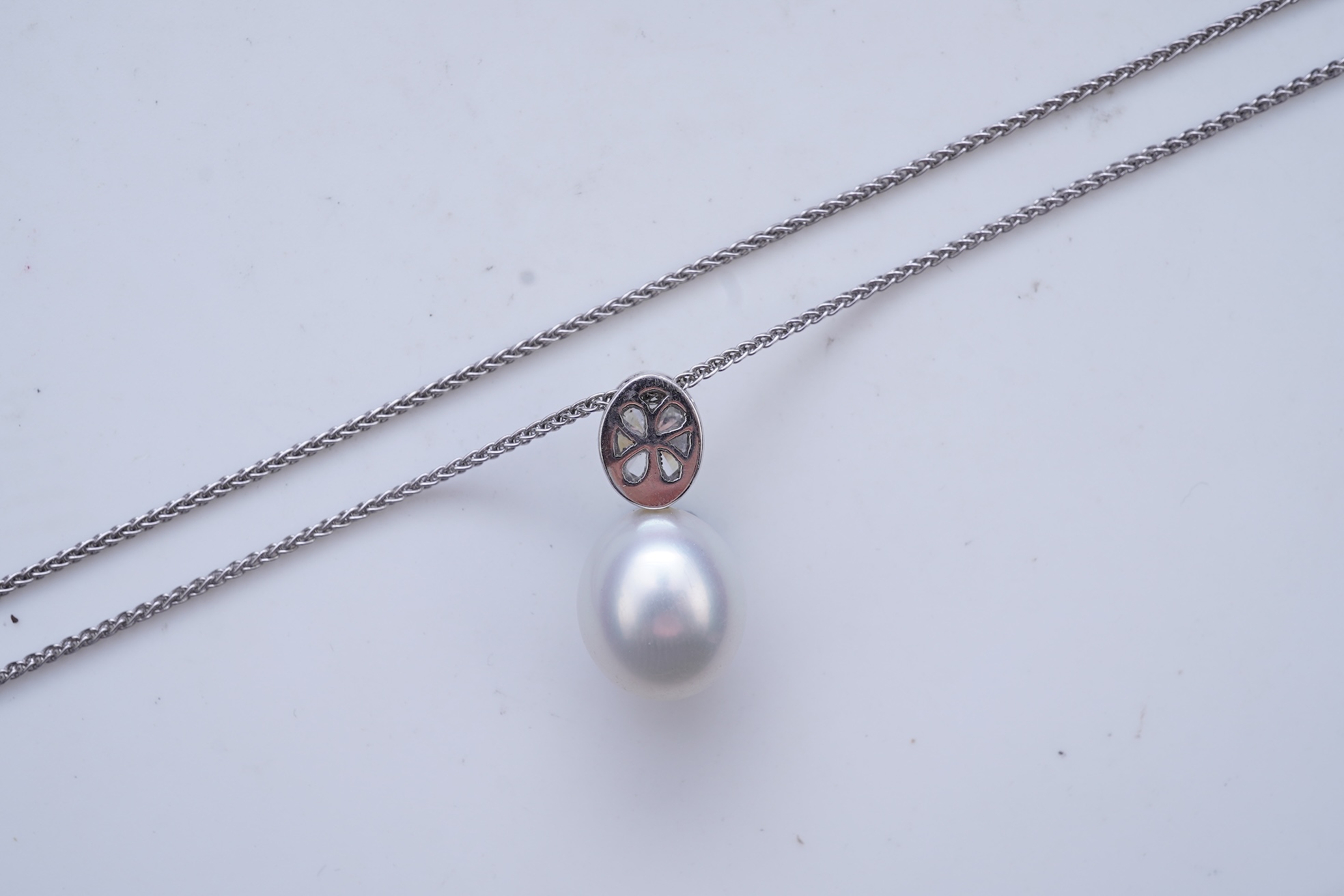 A cultured pearl and diamond pendant